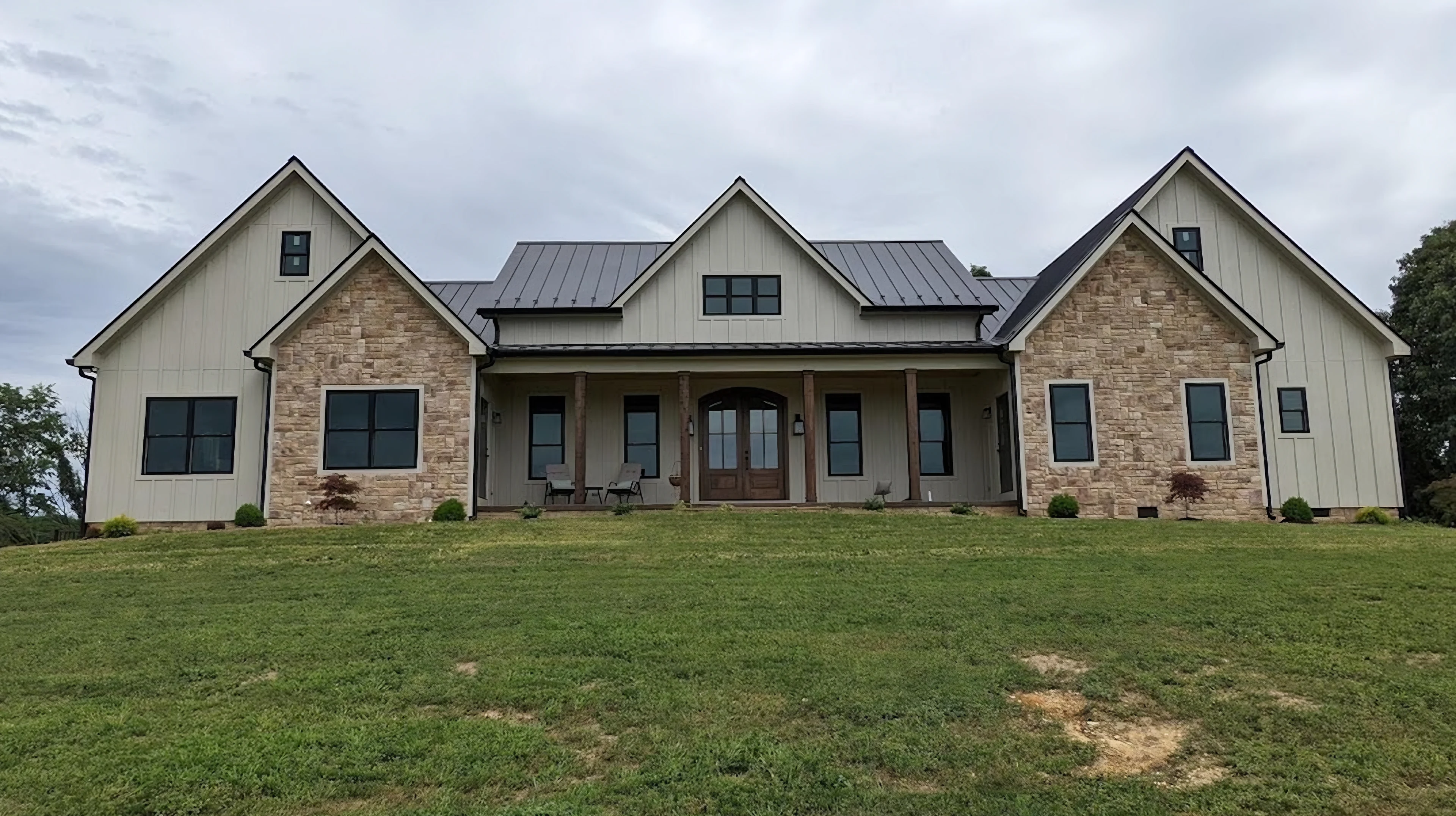House exterior with a broad front porch and stone accents