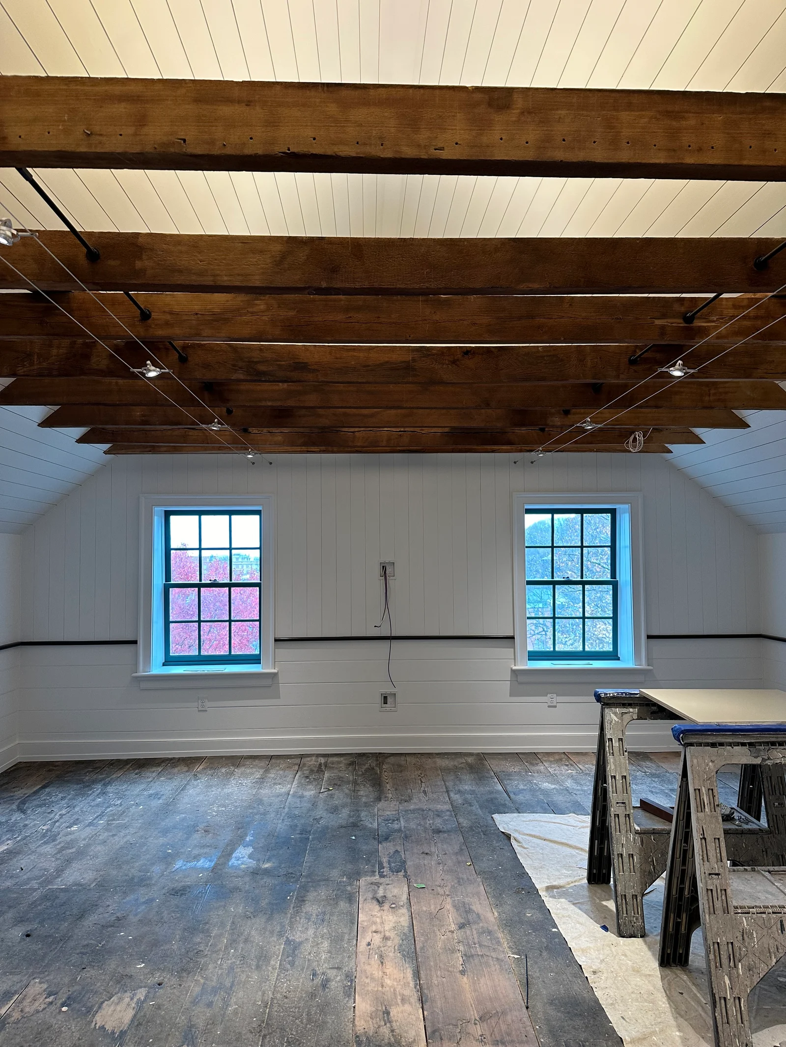Interior renovation with exposed wood beams, plank walls and sawhorses