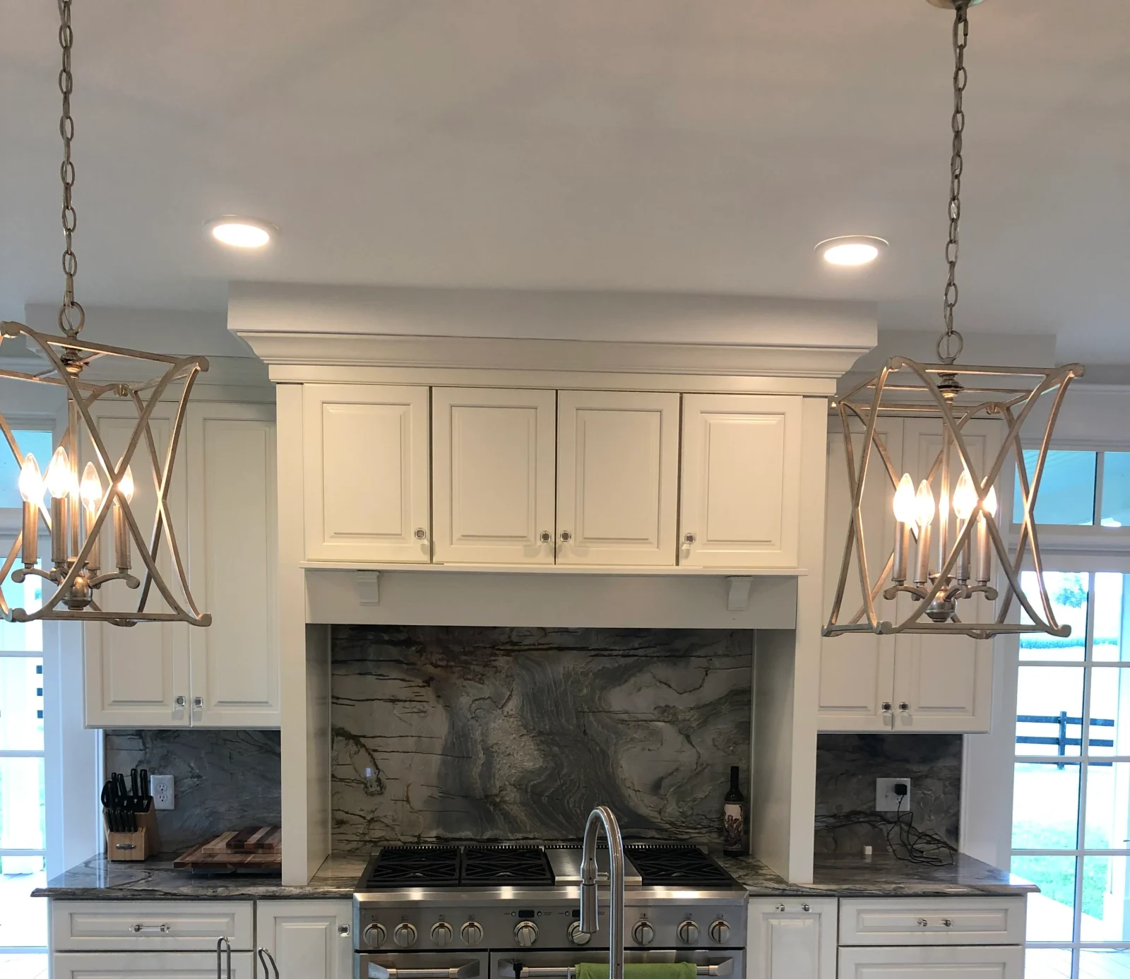 Kitchen cabinetry, lantern pendants and stone backsplash