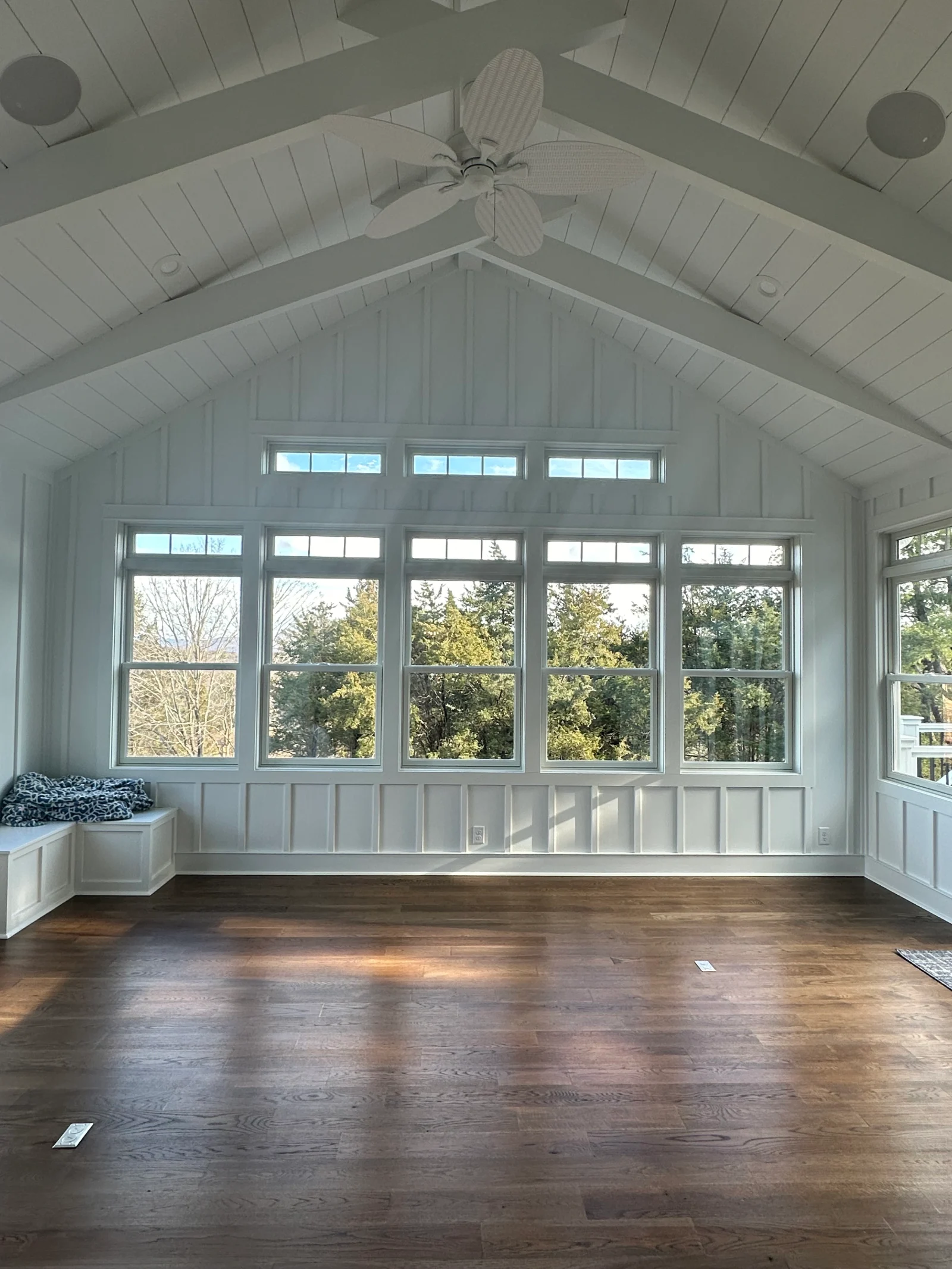 Sunroom with a vaulted ceiling and tall windows